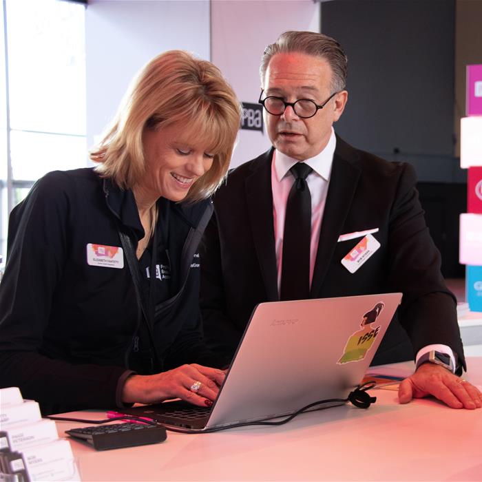 Two PBA employees looking at a laptop